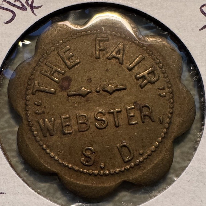 Webster S.D. The Fair Good For 50¢ In Trade Brass Scalloped Token