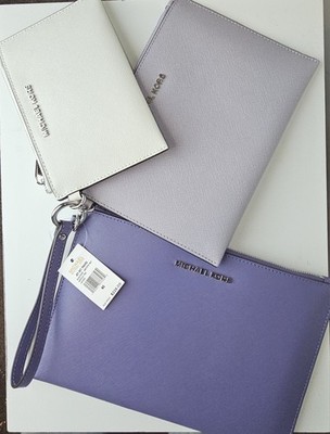 Michael Kors Jet Set Travel leather wristlets in white, lavender, and purple 