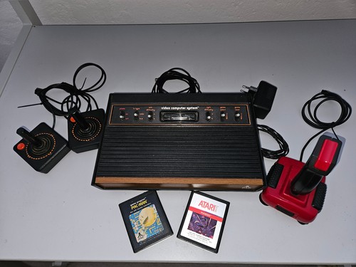 A vintage Atari CX-2600 video computer system, with two joystick