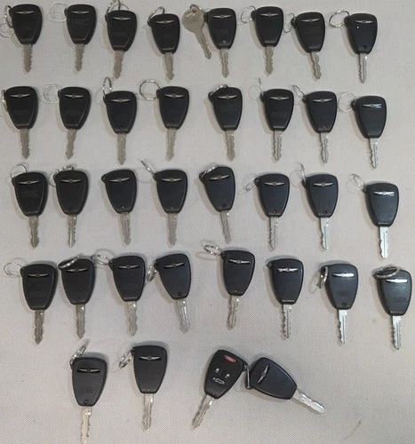 Lot of 35 OEM Chrysler Keyless Entry Remote Key Fobs with Keys Untested For Part - product listing photo