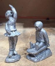 (2) Michael Ricker RB Pewter- '80 Doreen, Ice Skater & '80 Andy, Sledding Figure