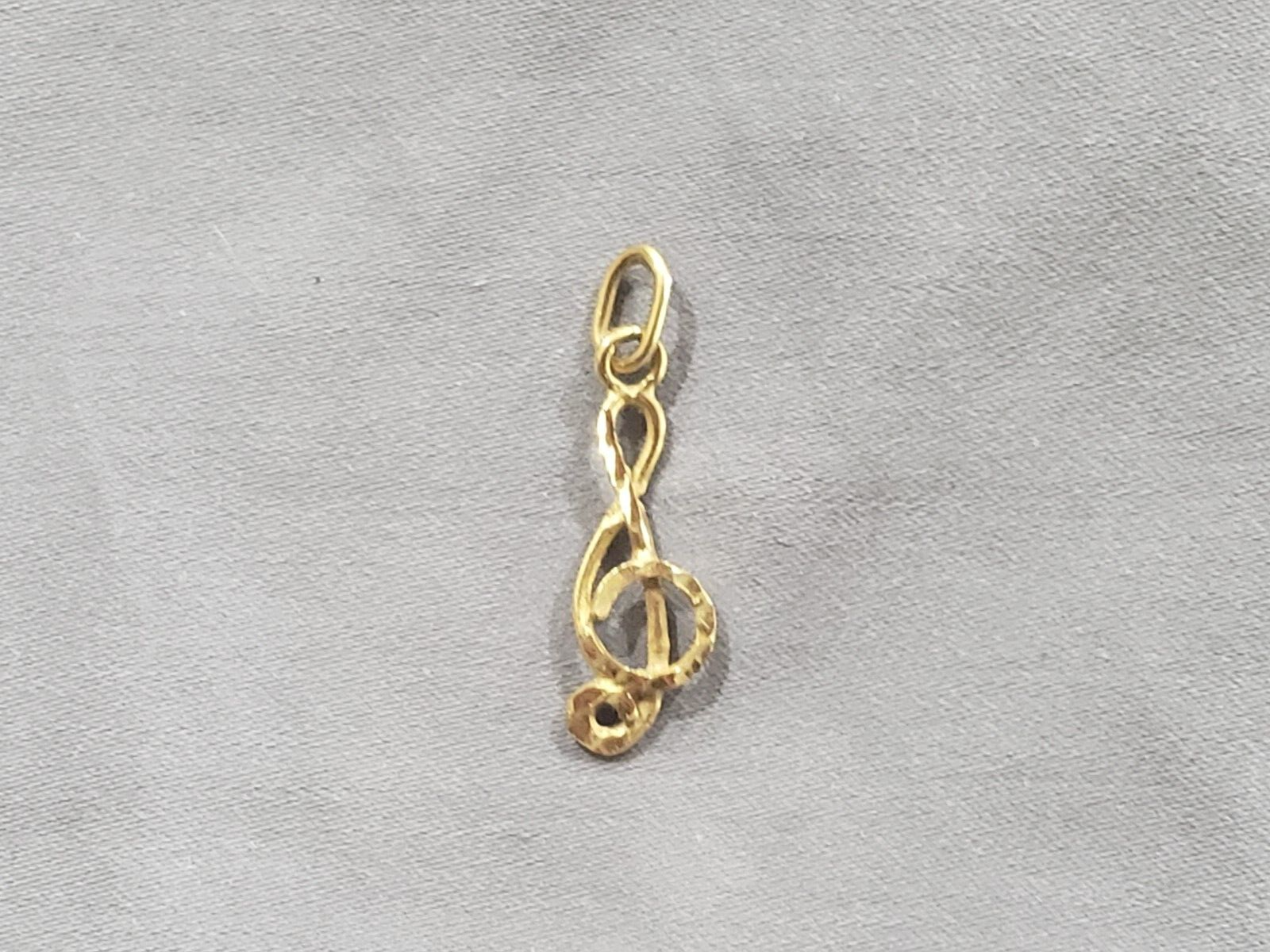 14K Music Note Pendent. .9gr