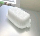 Vintage Art Deco Hazel Atlas milk glass half-stick butter dish with a lid.