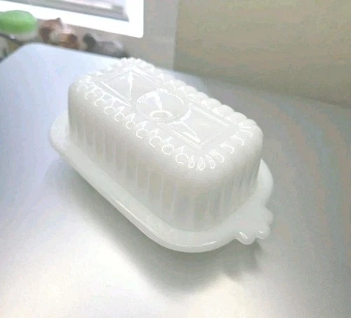 Vintage Art Deco Hazel Atlas milk glass half-stick butter dish with a lid.