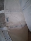White canvas tote bag with blue trim, tan shoulder straps, and visible LL Bean logo patch on front.