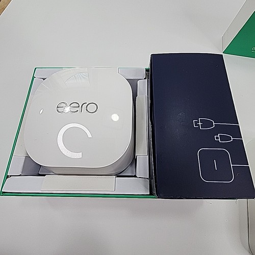 Eero 6+Plus dual band mesh WiFi router in green box with white logo, power adapter, and antenna.