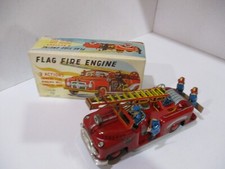 FLAG WAVING FIREMAN ON FIRE TRUCK- FRICTION WORKS -NEW IN BOX- ALL TIN -JAPAN
