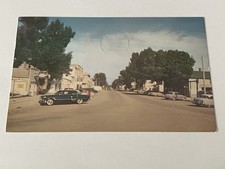 Postcard Street Scene Cars Stores Trees Sky V...