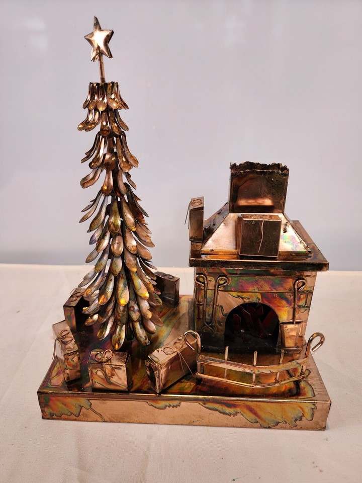 A spinning copper-tone tin Christmas tree music box playing 'We Wish You a Merry Christmas' — charming retro holiday decor that actually works.