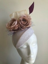 New white fascinator with silk abaca loops, flowers, netting and feather