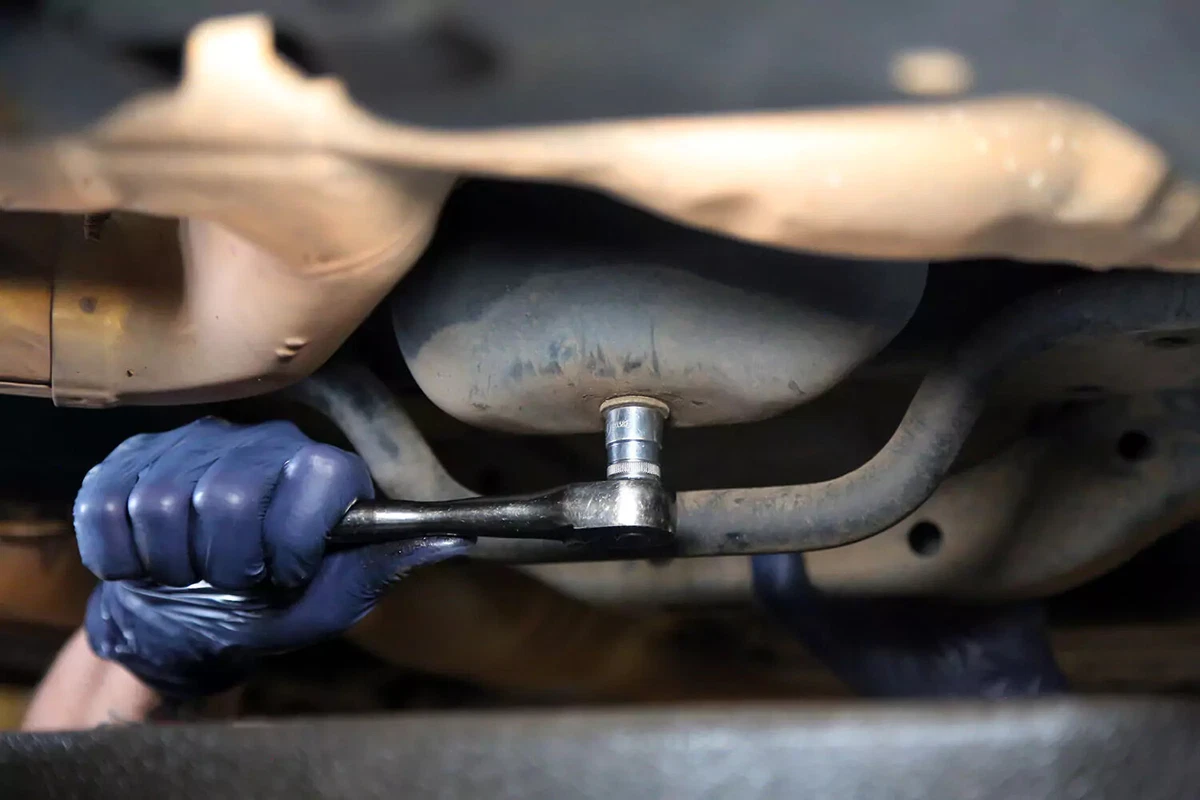 A ratchet attached to an oil pan plug.