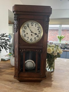 Vintage Wooden Pendulum Wall Clock with Ornate Detailing and Key