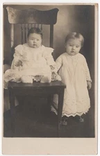 RPPC POSTCARD C. 1910s TWO YOUNG SISTERS IN WHITE DRESSES ORNATE CHAIR UNPOSTED