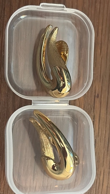 Signed Vintage Monet clip on earring in gold tone with texture. 1 x .5 inches.