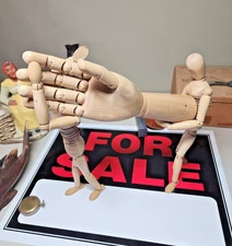 Two Wooden  Artist Mannequins walk into a bar holding hand.