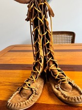 brown suede knee-high moccasin boots with fringed top and lace up closure -size