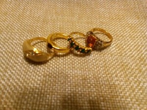 Authentic four gold plated rings, each with different color stones