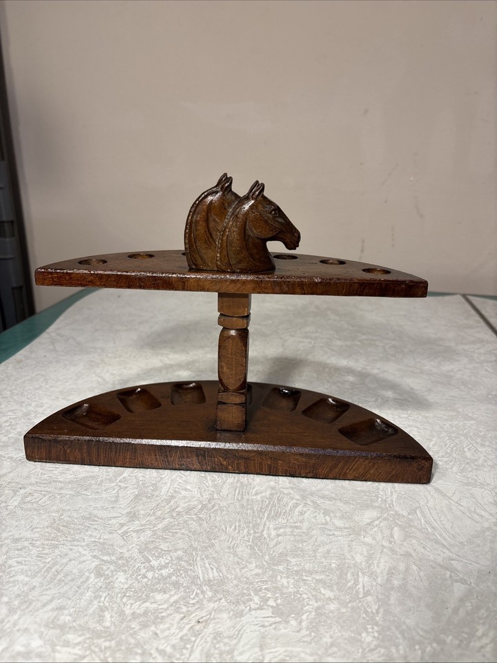 A genuinely odd vintage horse-shaped pipe stand/rack in rustic pipe-style — the kind of weird functional curiosity that anchors a whole shelf.