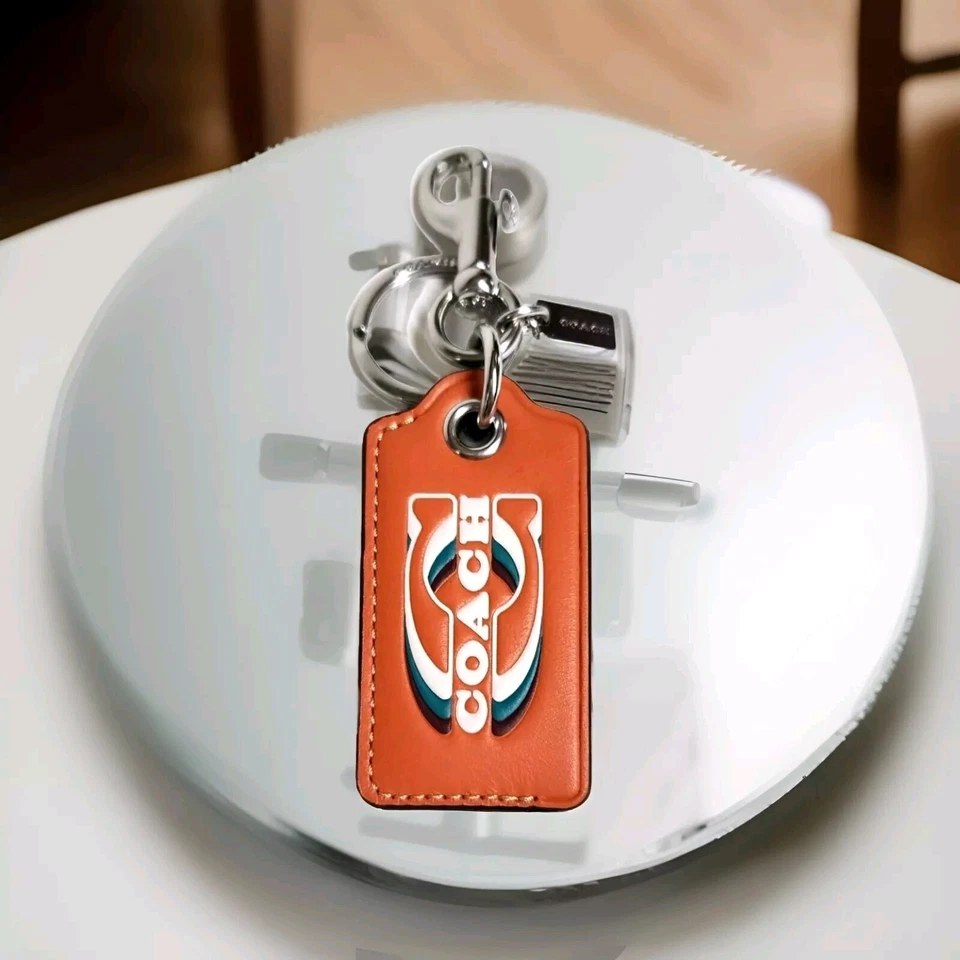 Llavero abridor de botellas Coach con sello plata naranja brillante cuero nuevo con etiquetas Foto 3 de 4