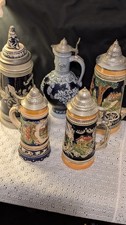 AN AWESOME, (LOT OF 5)-GERMAN BEER STEINS. GREAT CONDITION. 7"-12" TALL!