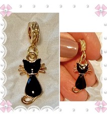 Charm / pendant - small black and gold tone metal cat. Back of cat. New Great