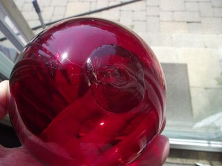 A BEAUTIFUL 4 INCH VINTAGE RUBY GLASS FISHING FLOAT WITH BUTTON PONTIL