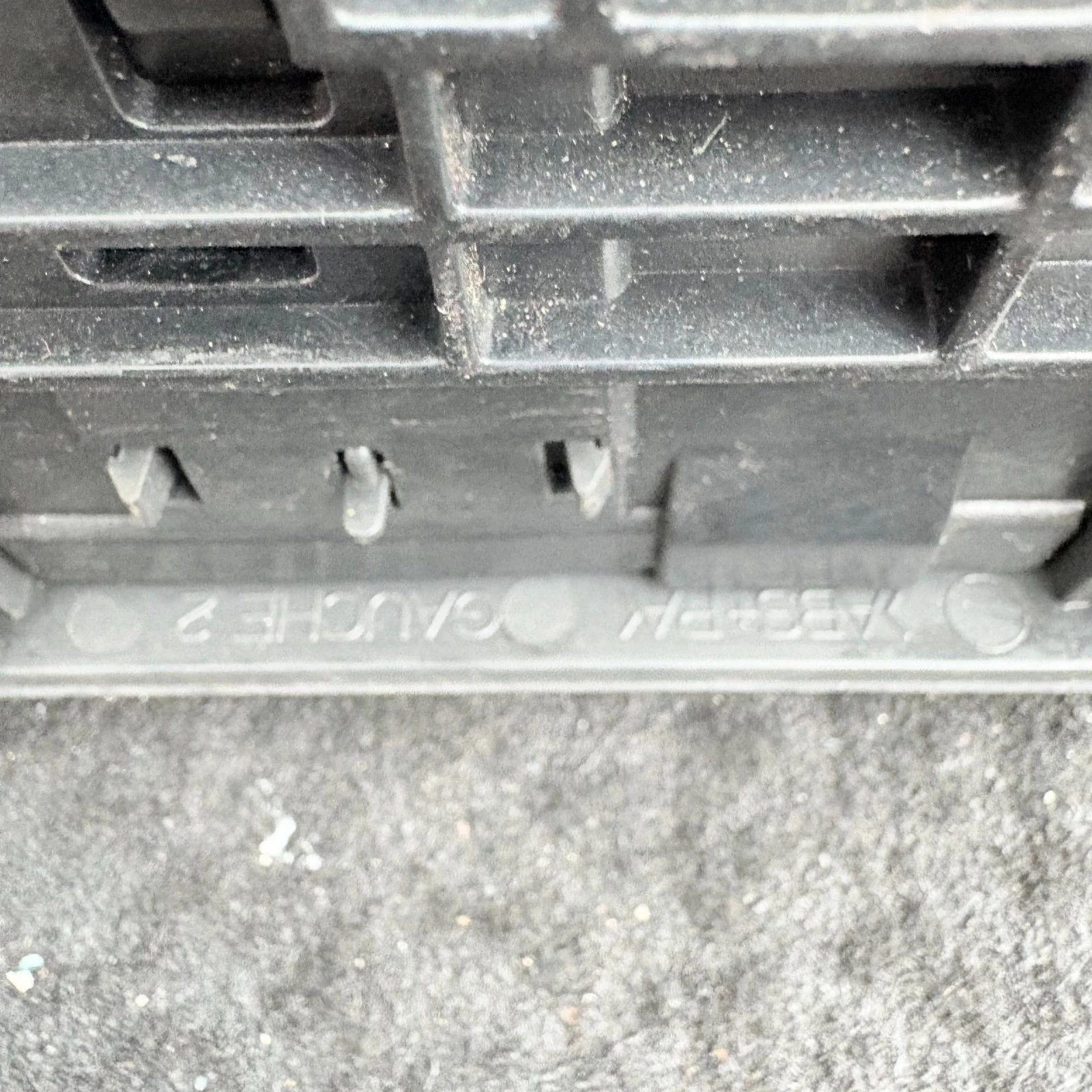 Close-up of Citroen C4 vent moulding showing left side and plastic material markings