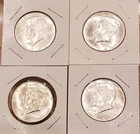 Four 1964 Kennedy half dollars