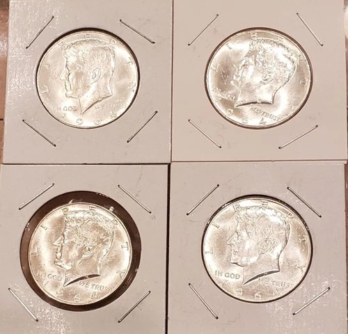 Four 1964 Kennedy half dollars