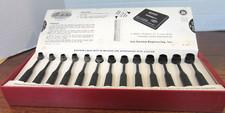 Lee powder measure kit with 13 measuring spoons and slide chart for reloading