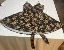Black floral fit-and-flare dress with a soft beige floral print.