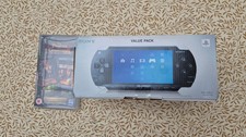Sony PSP-1003 Black Handheld Console, power cable and Pirates Of The Caribbean