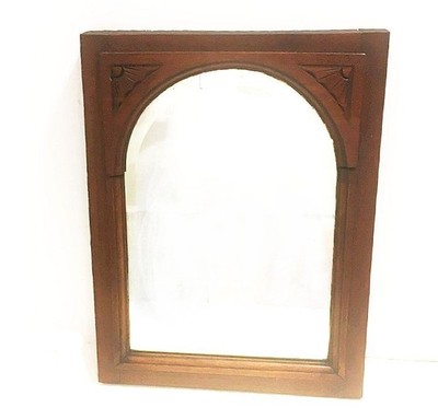 Antique mirror. Unknown wood stained dark walnut. Hand carved accents. Beveled.