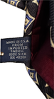 Vintage silk tie with blue diagonal stripes, gold knots, and white label reading “Made in U.S.A.”