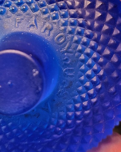 Cobalt blue glass votive candle holder with textured diamond pattern, embossed “FARO YOST” in white with red oval.