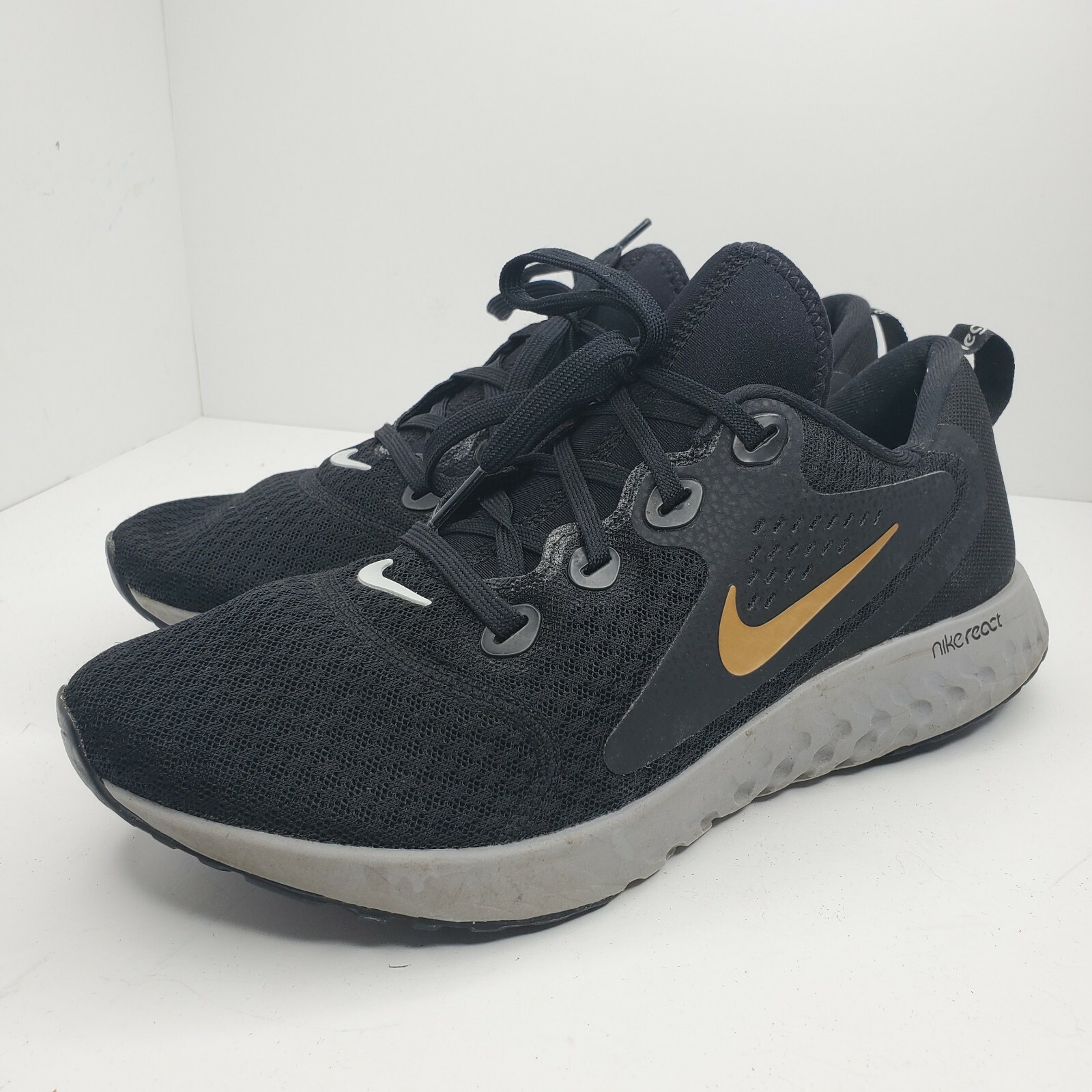 nike legend react black gold