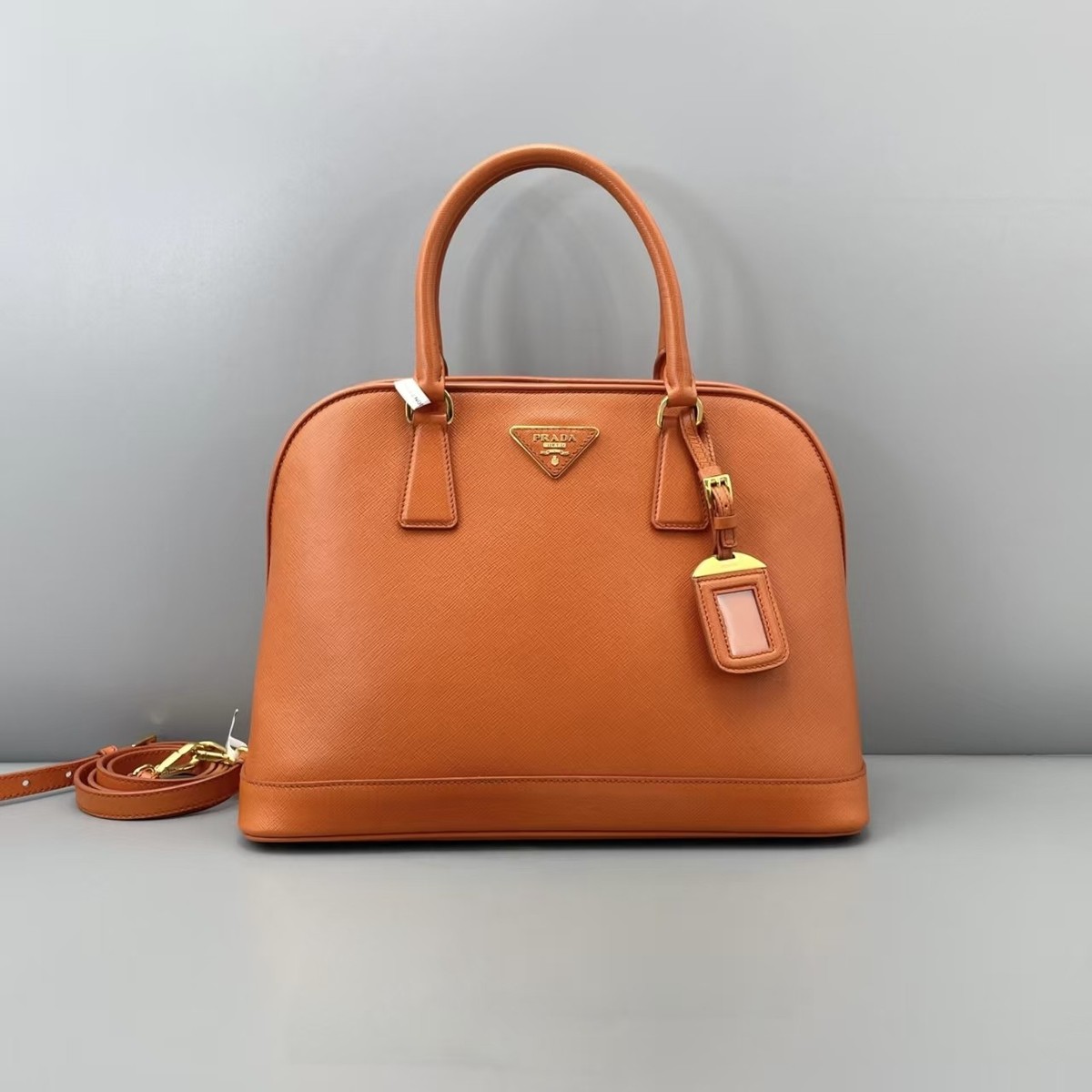 Authentic Prada Orange Saffiano Dome Handbag with Gold Hardware
