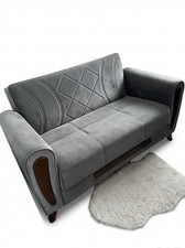 A Grey velvet 2-seater click-clack style sofa bed with a diamond-stitched Design