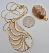 Two Gilded Shell Pendants of Varying Shapes and Sizes incl. yellow  Cobra Chain