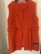 Red Prada sleeveless belted wool coat with hot pink detachable lining and Prada