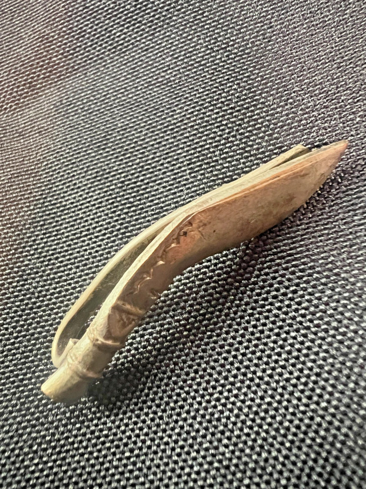 A mid-century tie bar shaped like a miniature sword/knife blade — the kind of tiny, weird, perfect detail that makes vintage menswear so much more fun than modern.
