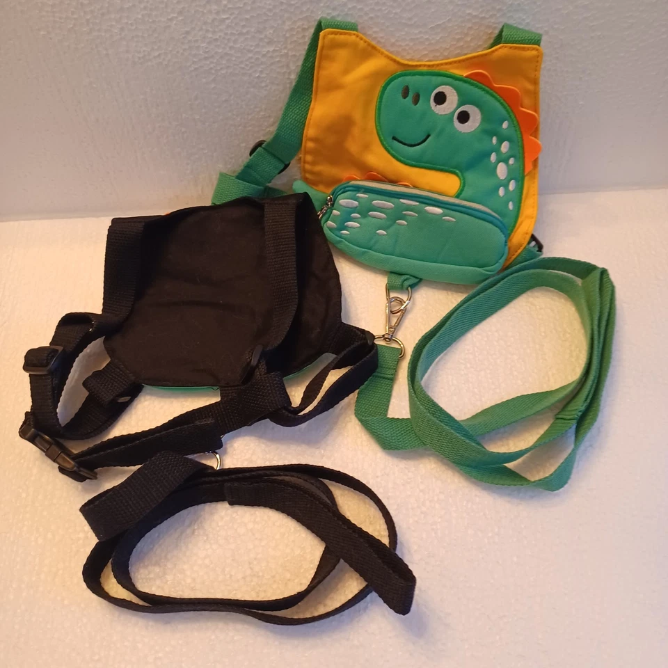 (2) ea. Arnés de seguridad para niños. Personajes de dinosaurio verde, 1 negro y otro amarillo. Foto 2 de 3