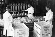 Milk bottles are cleaned machine then collected packed into c- 1930 Old Photo