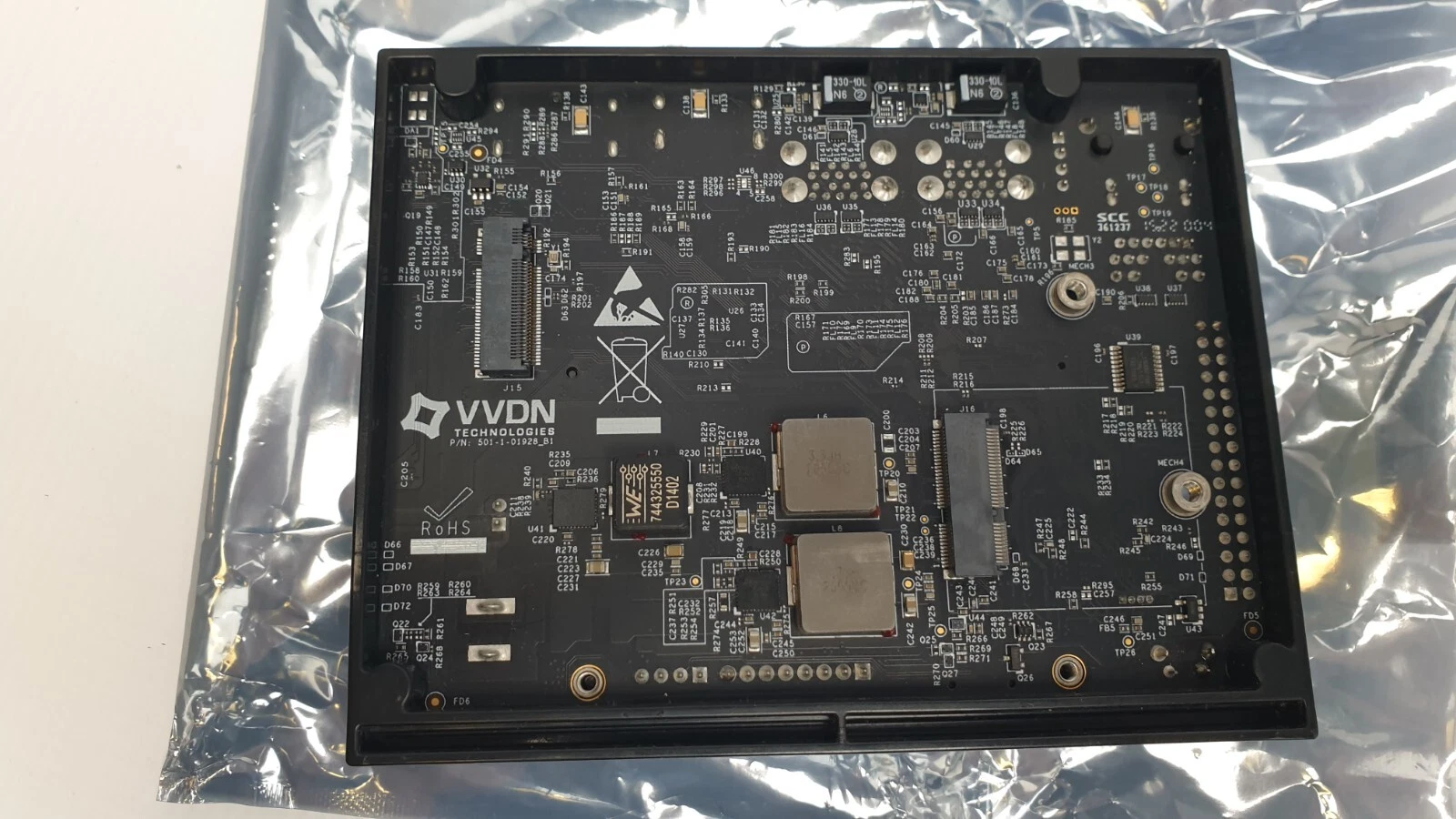 Underside of the VVDN carrier board in its plastic base, M.2 slots