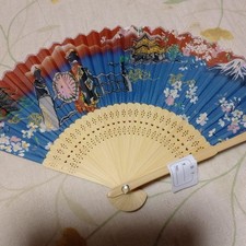 Japanese traditional folding fan with scenic design, paper and bamboo, used