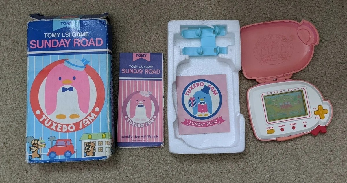 Tomy Tuxedo Sam Pink Sunday Road Electronic Handheld LSI