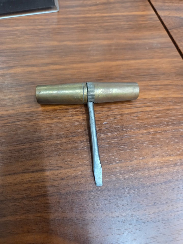 A 1920s German brass 'Roundlet' multi-tool — a tiny cylindrical antique that unfolds into 4 screwdriver bits and looks like something from a steampunk apothecary.