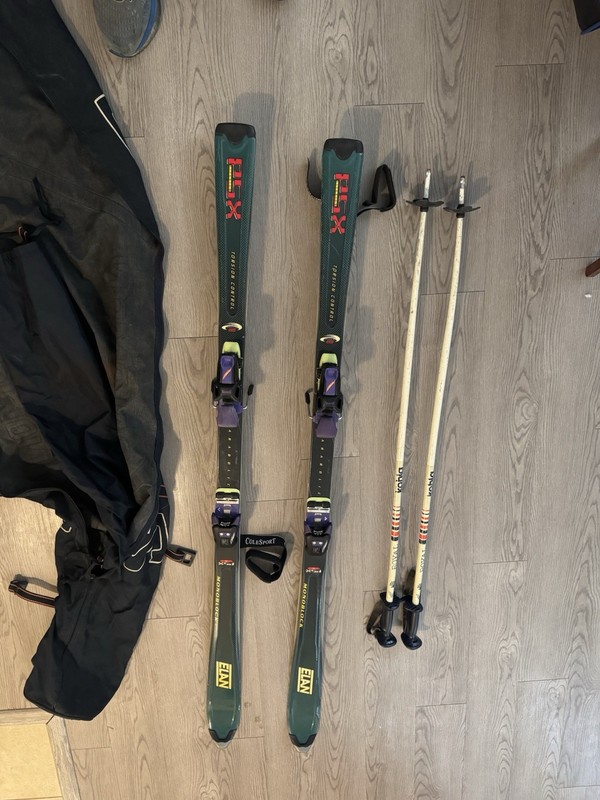 vintage Elan PSX Titanium Monoblock skis, Solomon ski bag, and ski poles