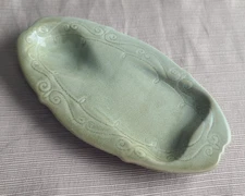 Glazed ceramic sage green spoon rest with quilted edge pattern