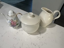 Miniature floral pattern tea pot, and cream creamer sugar bowl. Pre-owned.